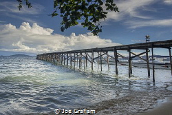 Jetty bathed in the early Morning Sun! Raja Ampat Dive Re... by Joe Graham 